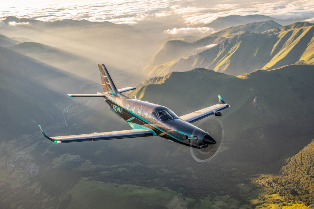 A DAHER TBM960 flying in beautiful mountainous terrain