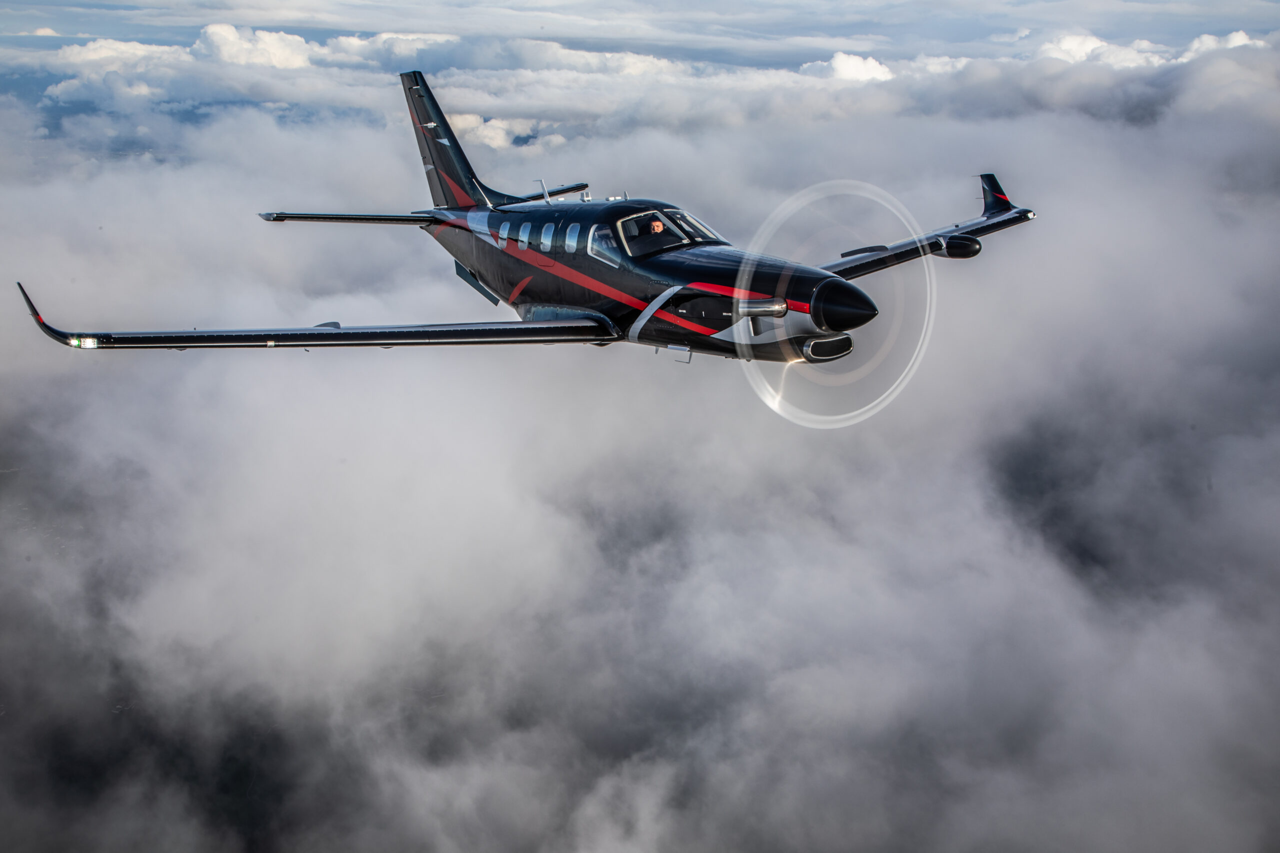 A DAHER TBM960 painted in black with a red and silver trim
