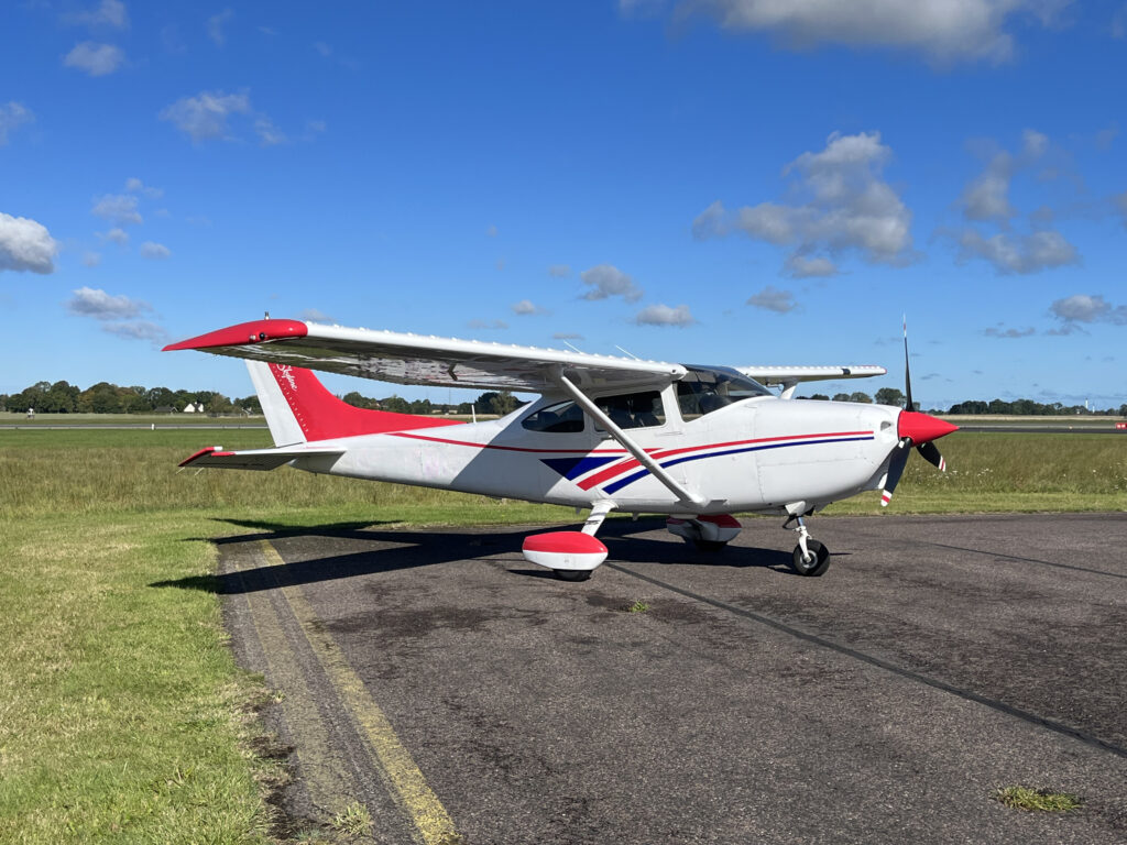 Cessna C182 parked on the apron in a small airport