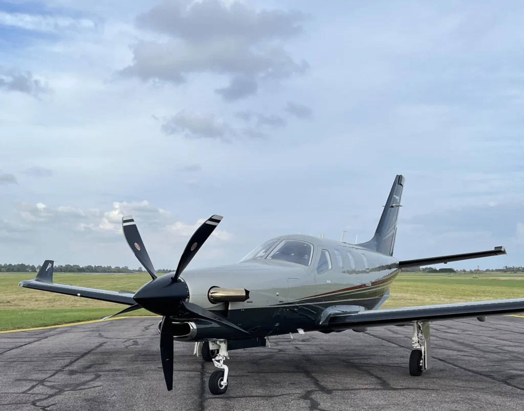 A TBM 940 parked near the holding point for runway 24