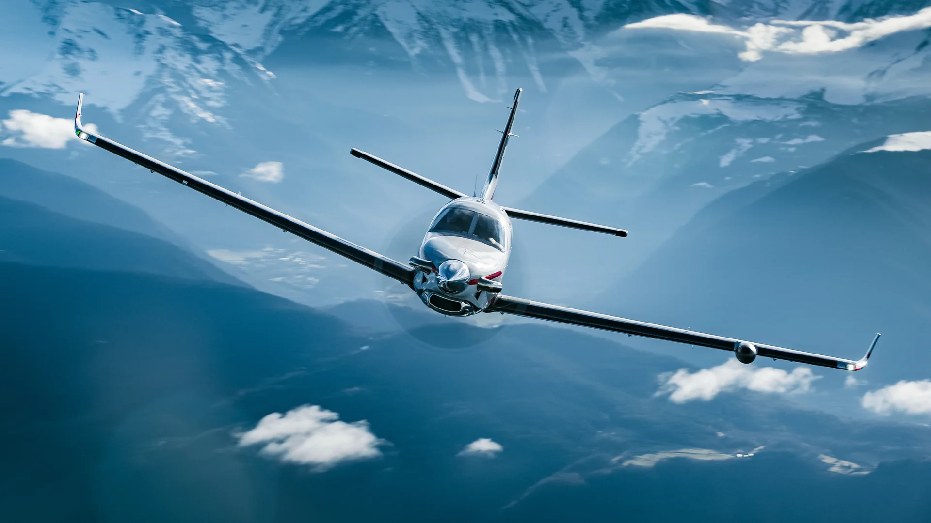 A Daher TBM 960 in smooth flight over mountains